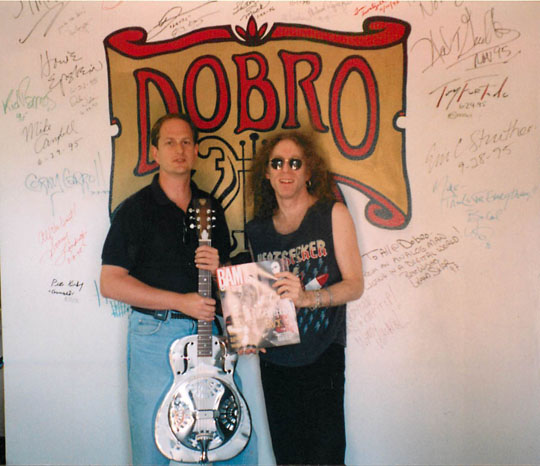 Mike Replogle presenting Waddy Wachtel with a Dobro guitar 1997 at the Dobro Wall.
